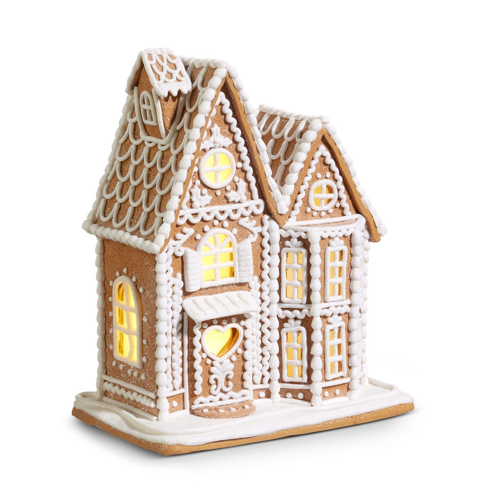 12-inch lighted gingerbread house made of clay dough with white icing details and warm glow windows