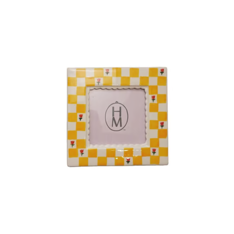 Square stoneware photo frame with a yellow and white checkered pattern and small red flower motifs.