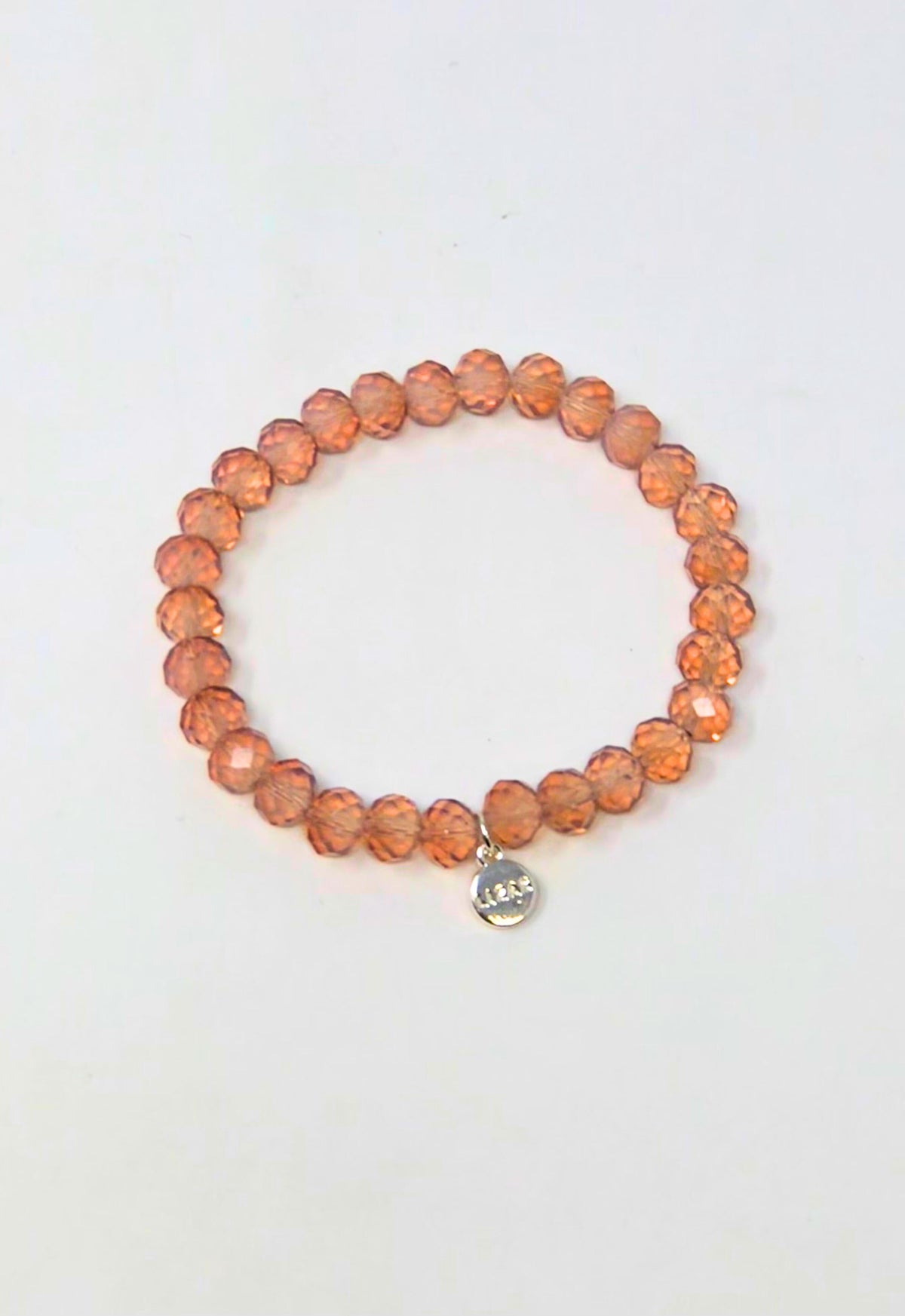 Stretchy bracelet with faceted glass beads in a colorful beaded pattern.