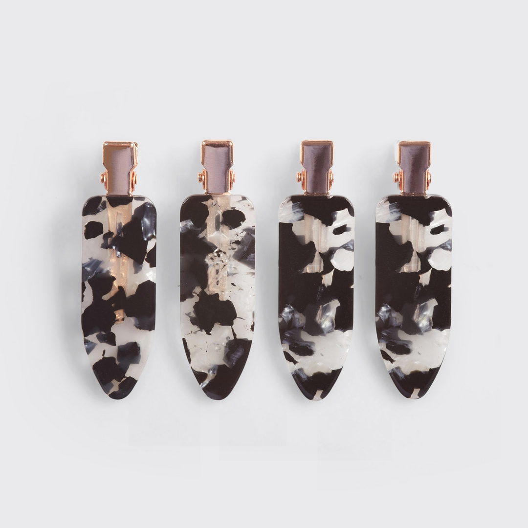 Set of four eco-friendly creaseless hair clips in a black and white marble pattern.