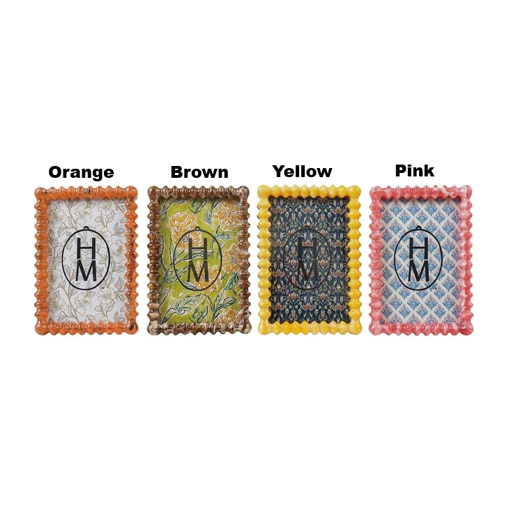 Four marbled resin spindle frames with scalloped edges in orange, brown, yellow, and pink.