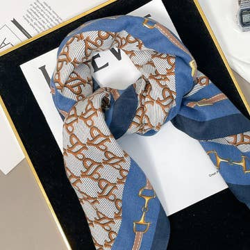 Blue and white velvet scarf with a brown chain print and gold bit details.