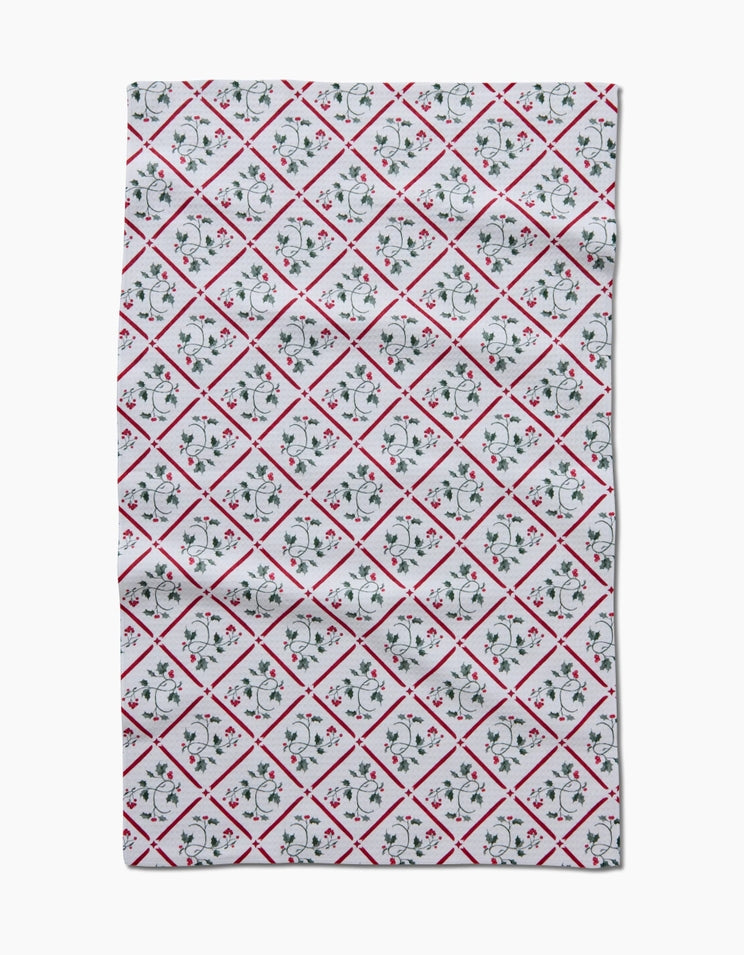 Holiday tea towel with waffle weave construction in red featuring a festive snowflake pattern.