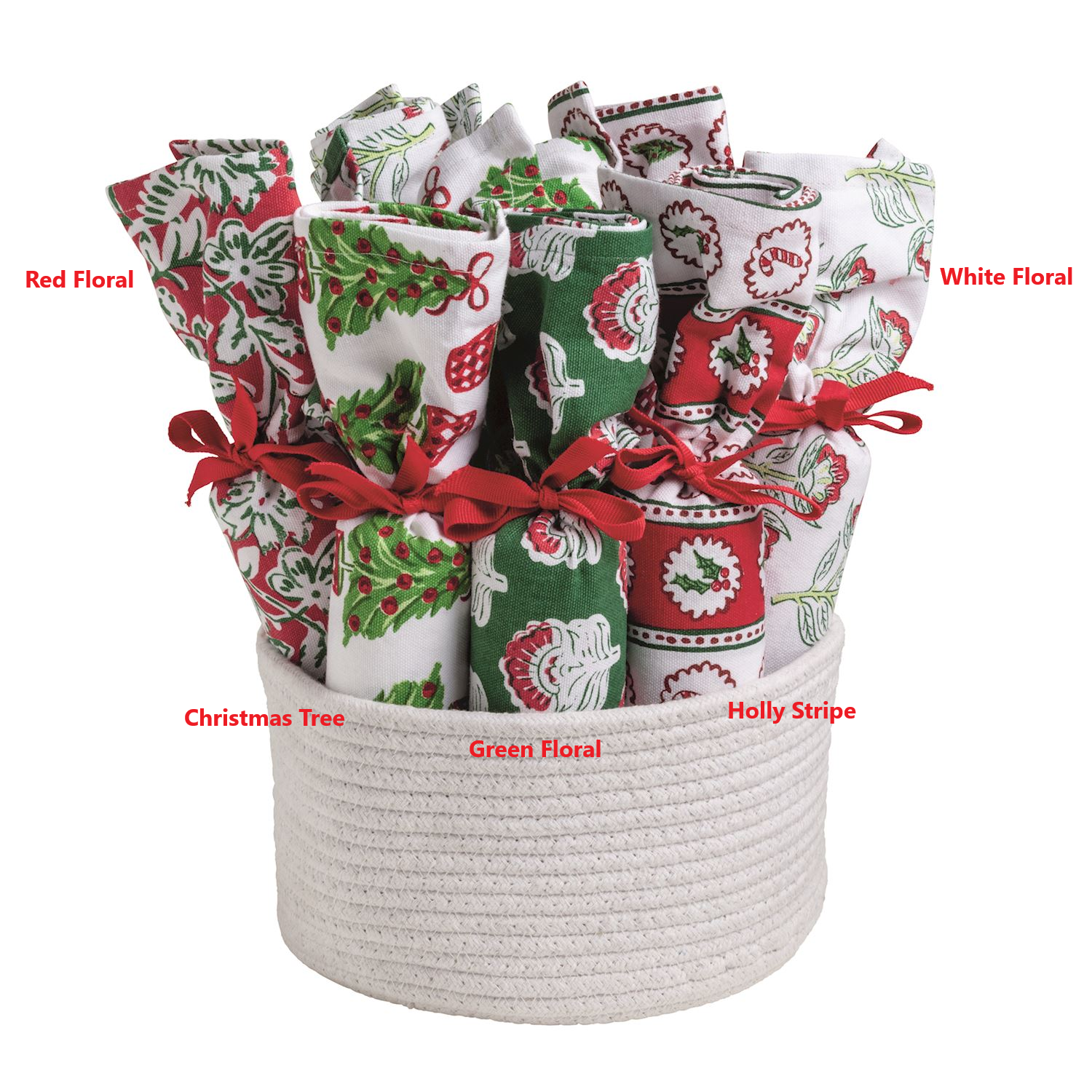 Five Christmas block print towels rolled and tied with red ribbons in a white rope basket.