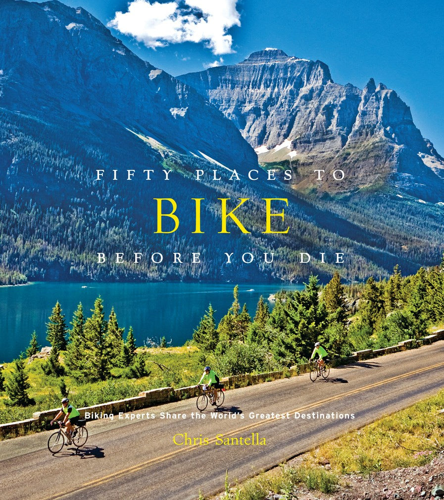 Hardcover travel guide Fifty Places To Bike Before You Die with colorful cycling destination illustrations on the cover.