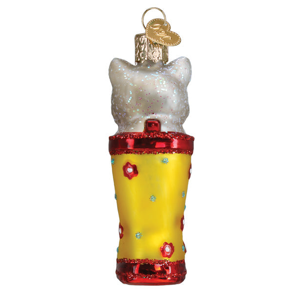 Back view of a glittery white kitten sitting inside a yellow rain boot Christmas ornament.