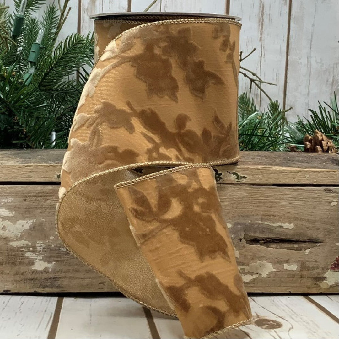 4 inch wide gold velvet sheer ribbon with a floral garden pattern on a wooden background.