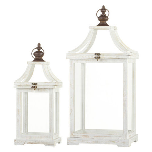Set of weathered white wooden lanterns with iron accents and glass panels.