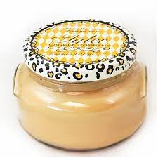 A large 22oz Tyler Candle in a clear glass jar with an off-white wax and black wick.
