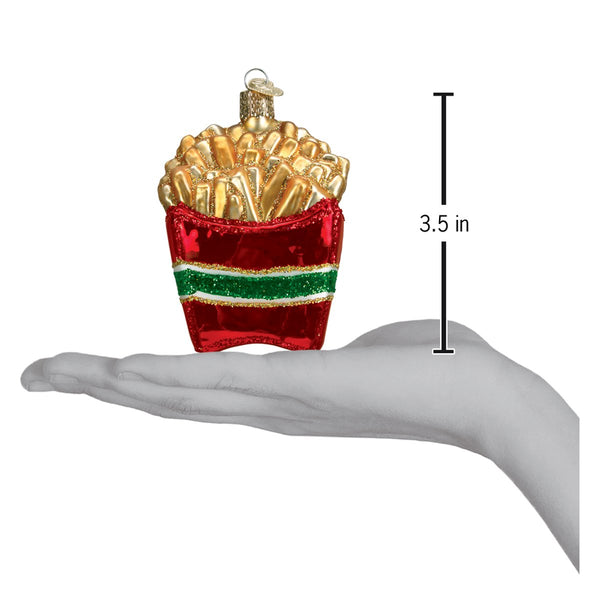 French fries glass ornament in a red container, 3.5 inches tall, held in a hand for scale.