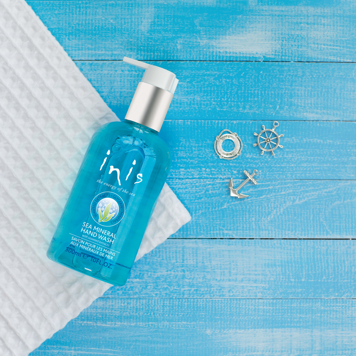 Bottle of Inis Sea Mineral Hand Wash with a white label featuring green seaweed and mineral illustrations.