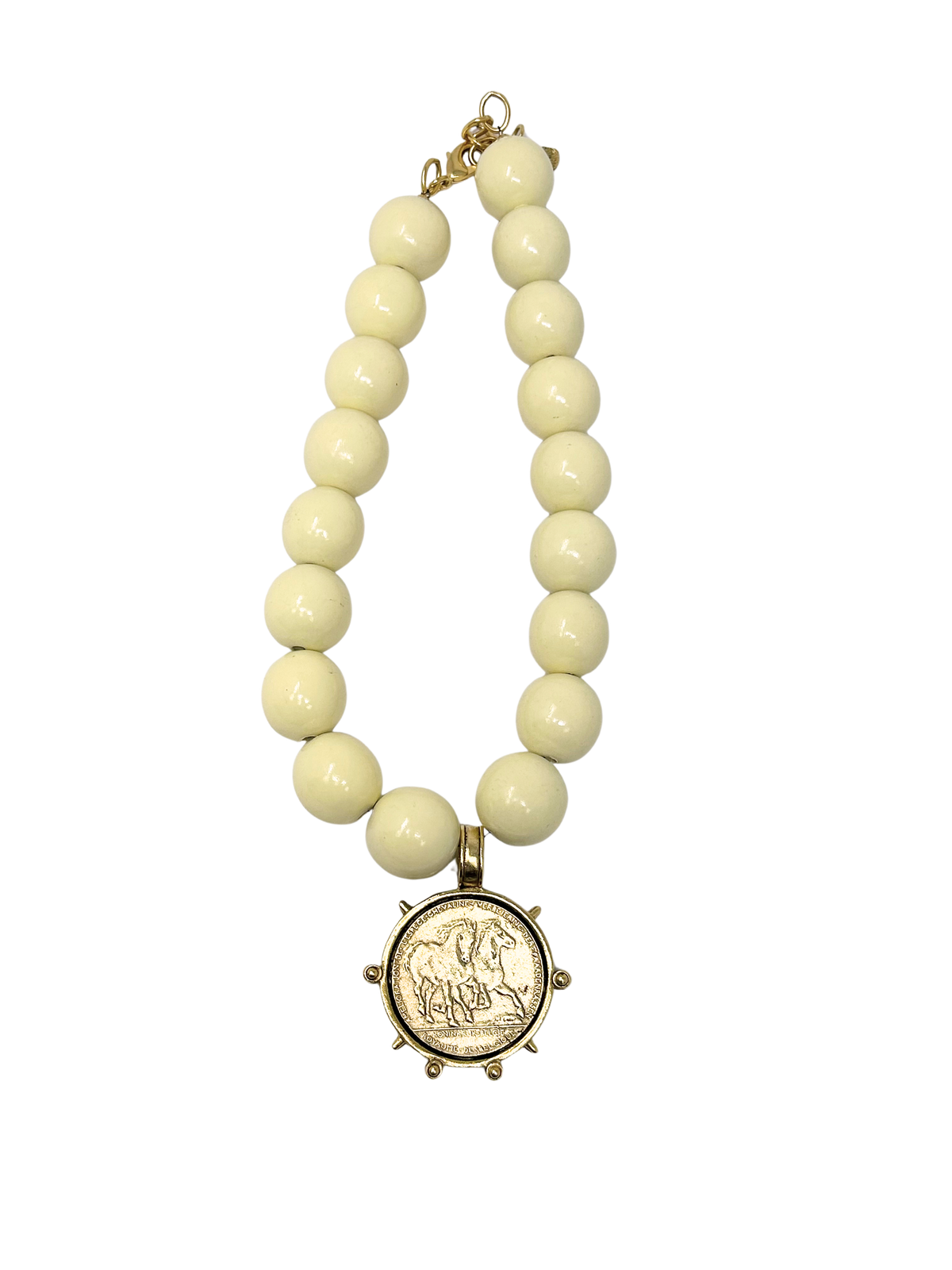Vintage 18-inch necklace featuring large cream-colored beads and a gold coin medallion pendant.