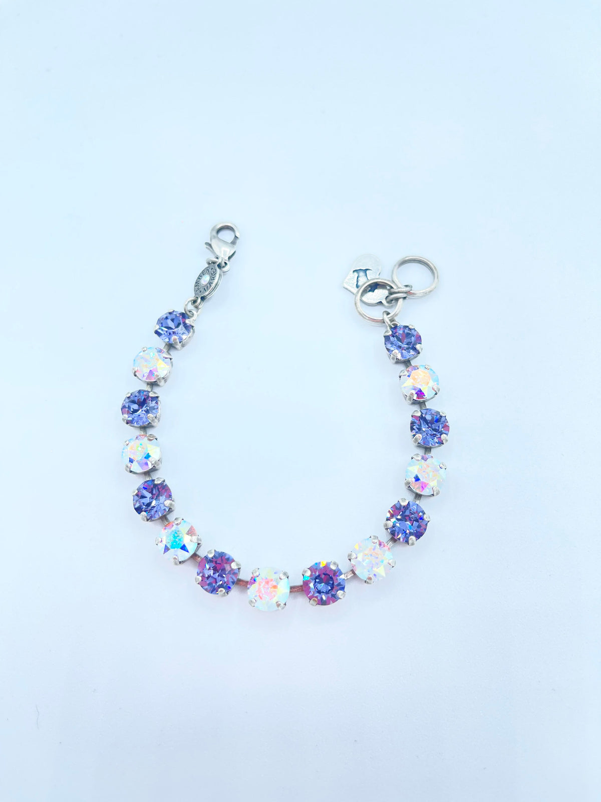 Classic bracelet in lavender, lilac, white, and light green stones with an amber tag featuring a Scotty dog heart charm.