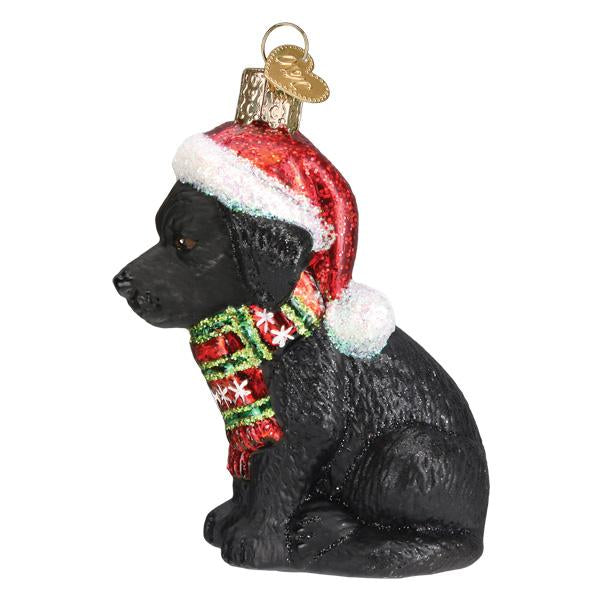 Holiday Black Labrador Puppy glass ornament wearing a red Santa hat and a festive striped scarf.