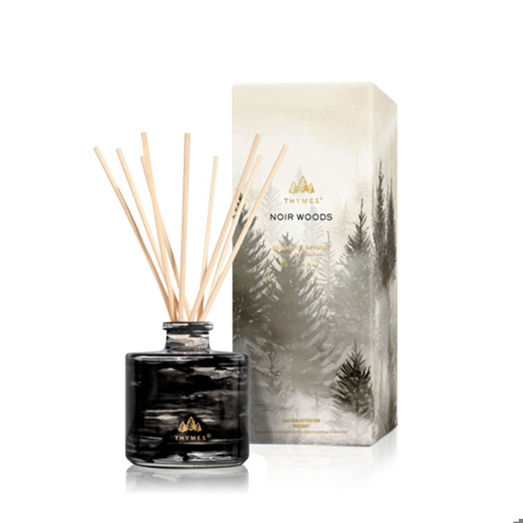 Thymes Noir Woods Petite Reed Diffuser with black marbled glass bottle and decorative forest box.