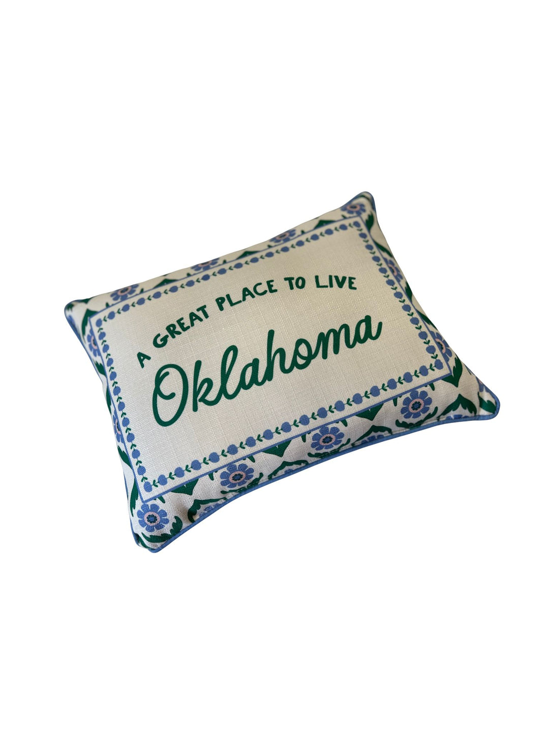Rectangular pillow with blue floral block print border and green text: A GREAT PLACE TO LIVE Oklahoma