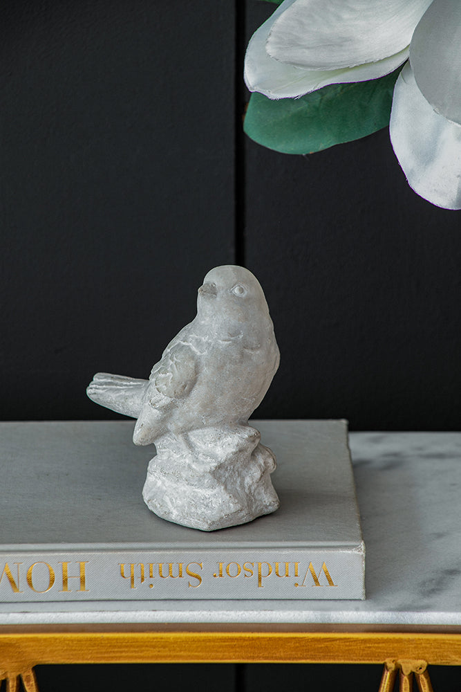 Skye Watchful Bird cement sculpture in natural gray tone with a bird silhouette looking right.