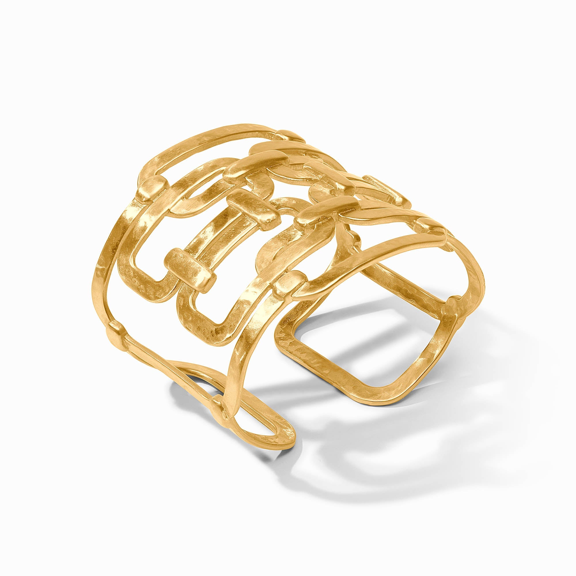 Sahara Statement Cuff, a wide gold-toned bracelet with an open, interlocking geometric design.