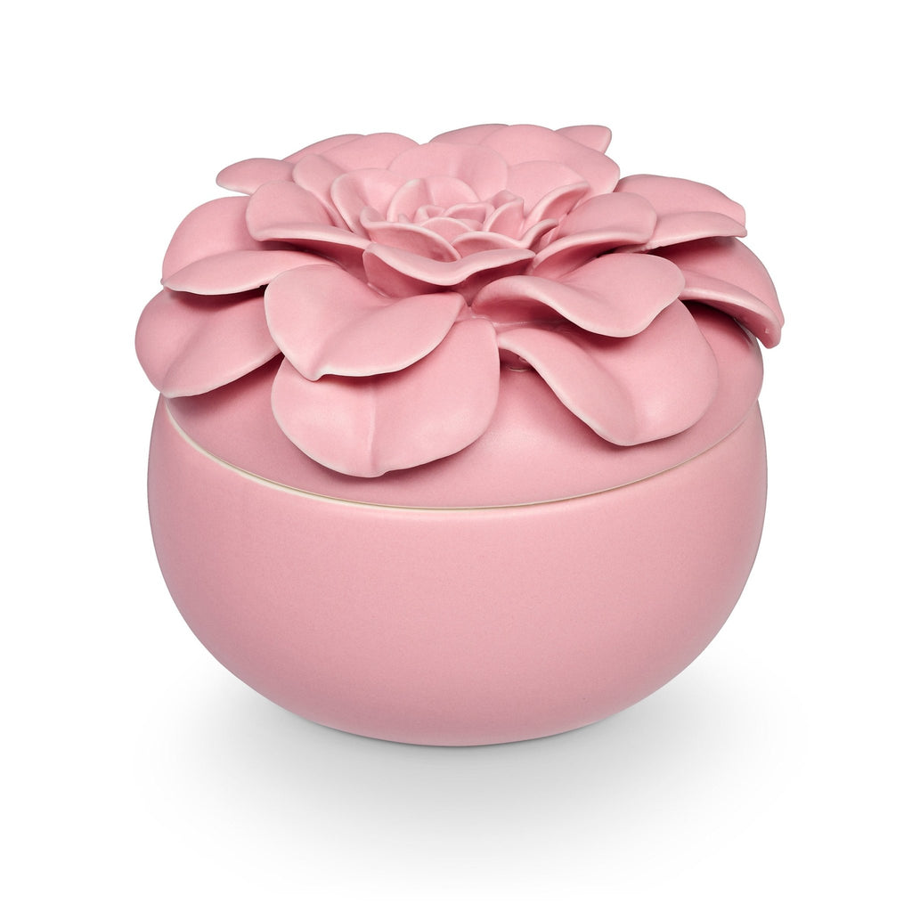 Ceramic flower candle with three wicks in a petal-shaped vessel filled with plant-based wax.
