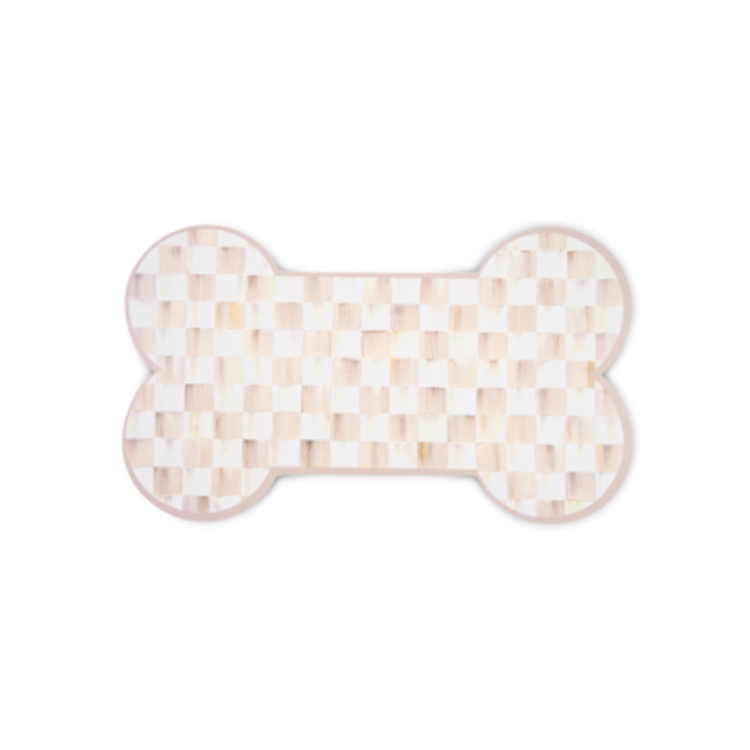Bone-shaped placemat with a light pink and white checkered pattern.