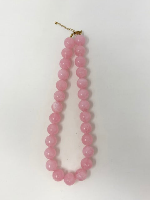 Chunky round pink beaded statement necklace with a gold-tone adjustable chain clasp.