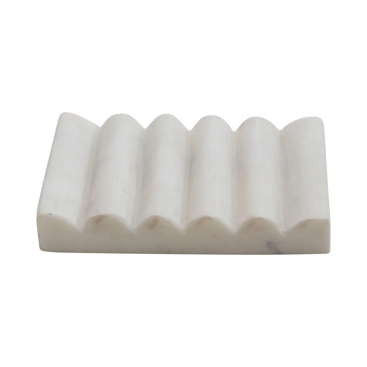 Rectangular white carved marble soap dish with a wavy, grooved surface for drainage.