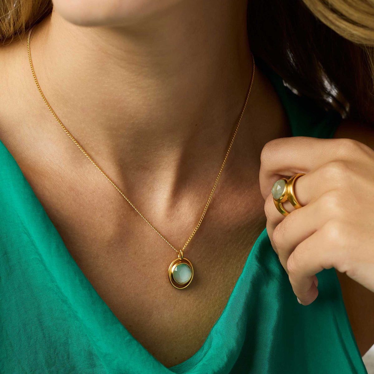 Adjustable Laguna Solitaire necklace featuring a clear imported glass pendant on a 24K gold plate chain.