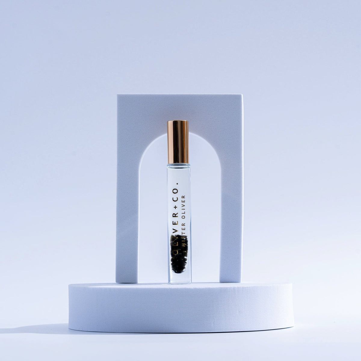 Bougie Stick roll-on perfume by Oliver + Co. in a clear glass vial with a gold cap.