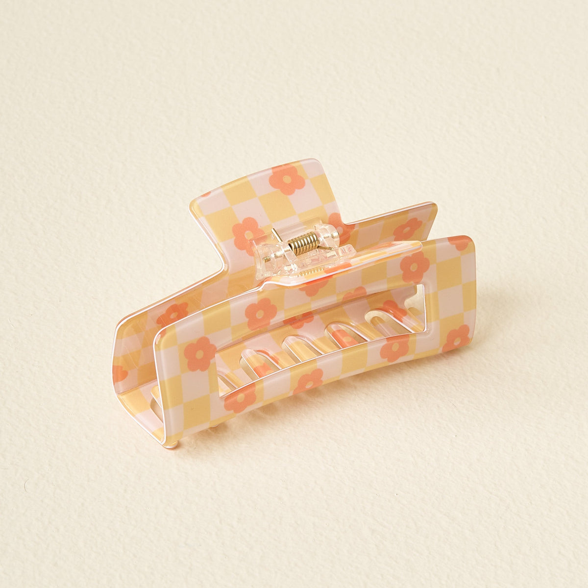 Clear plastic check claw clip with printed checkerboard pattern