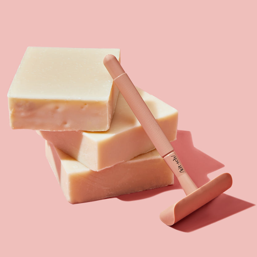 Shave Butter Bar in a clear bottle-free container with visible creamy beige butter texture.