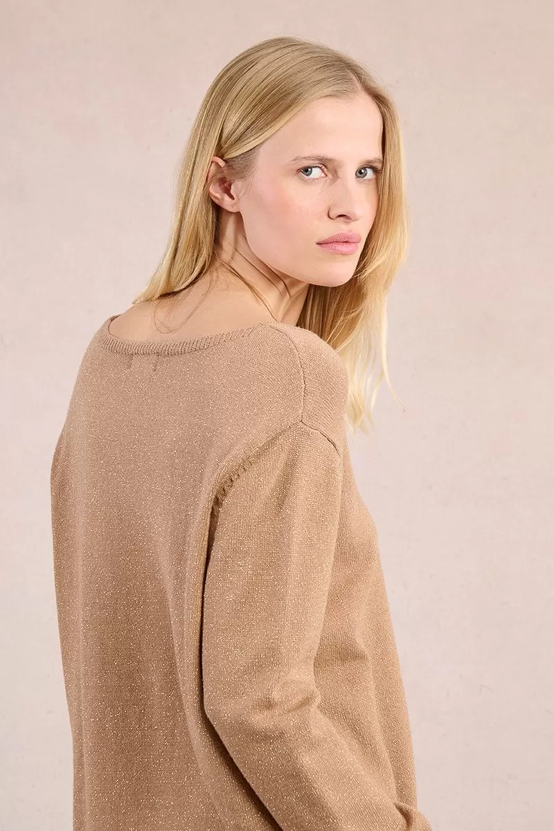 Back view of a woman wearing the Lesli Ladies Knitted Sweater in a shimmering tan color.