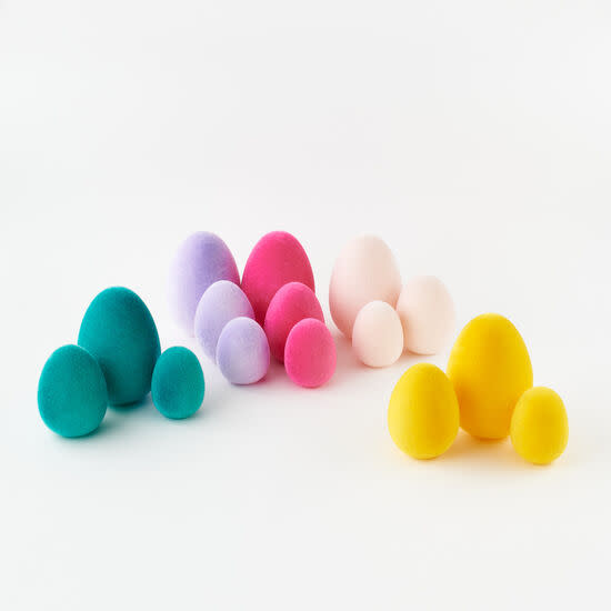 Flocked egg-shaped PVC decoration in a soft pastel hue with a textured matte finish.