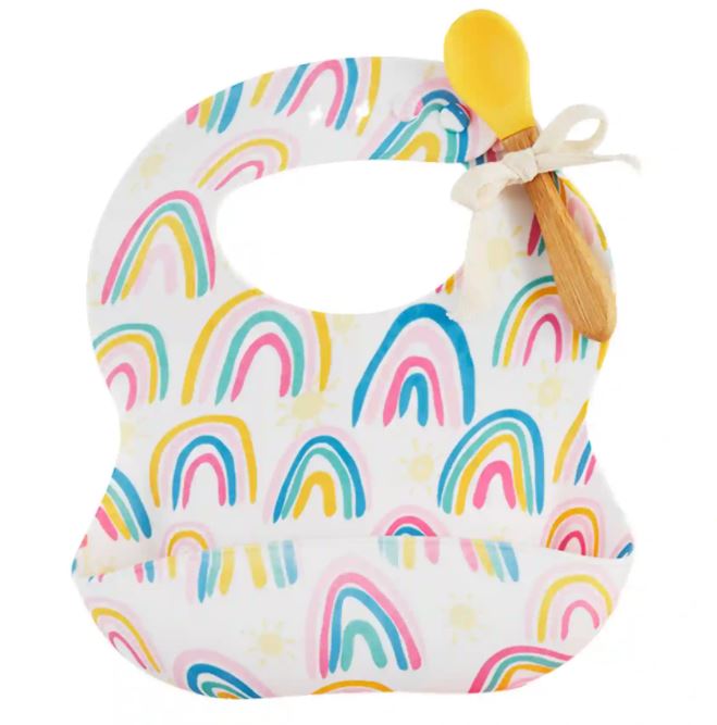 Two-piece baby feeding set with white silicone bib featuring rainbow icons and a yellow wood-handled spoon.
