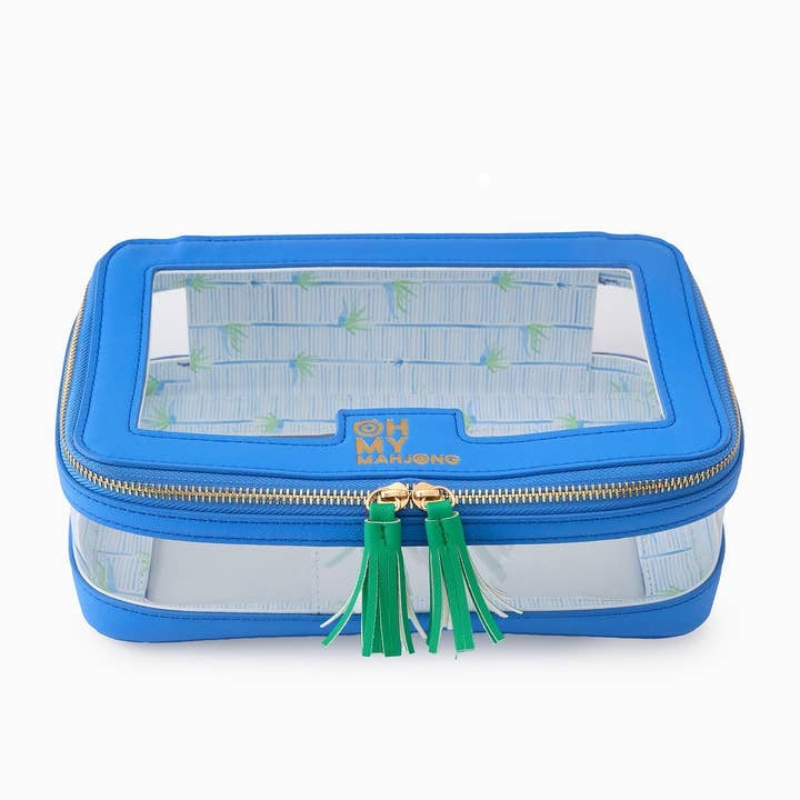 Blue zippered storage bag with label window holding a full set of mahjong tiles.