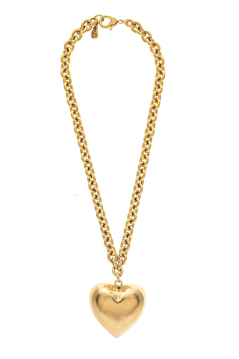 Gold chain necklace with a large, polished heart-shaped pendant.