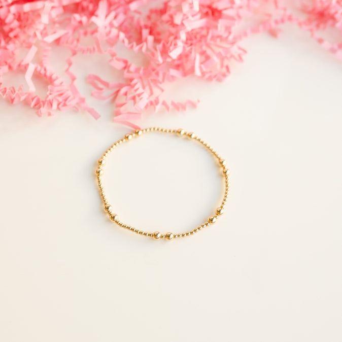 Gold Bethani bracelet featuring a delicate chain link with an ornate filigree pendant.