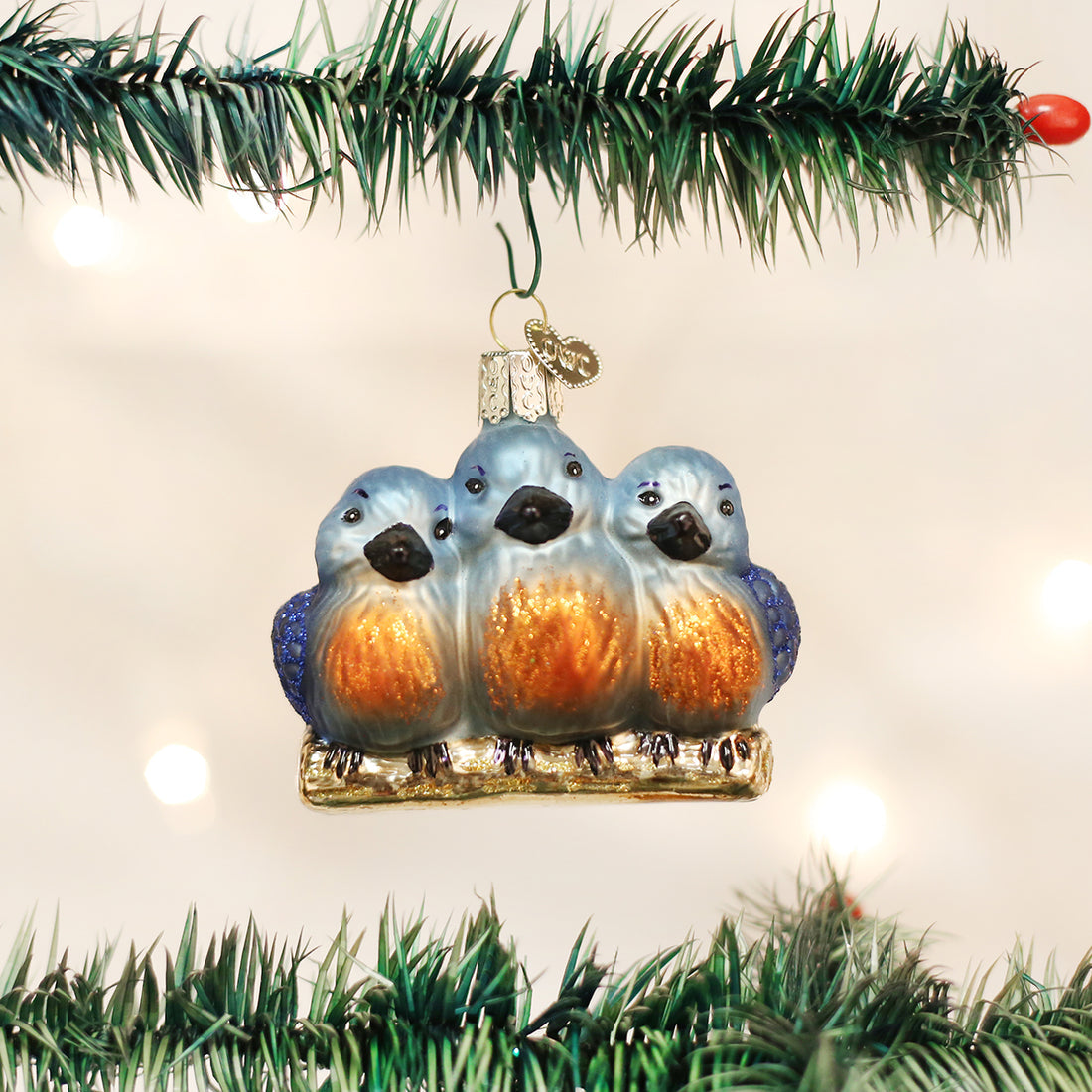 Glass Feathered Friends ornament featuring three blue and orange birds on a branch.