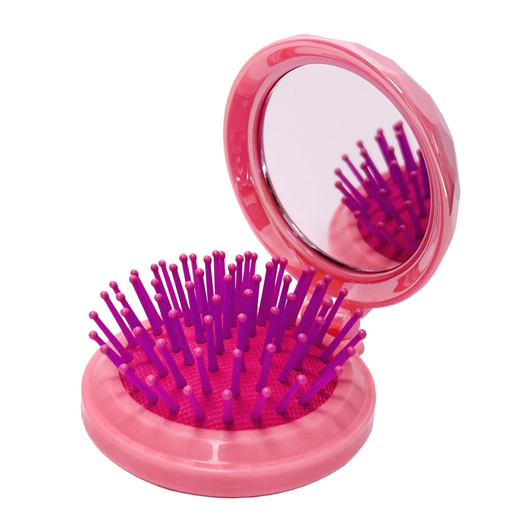 Foldable ABS hairbrush with a round jeweled mirror top in black.