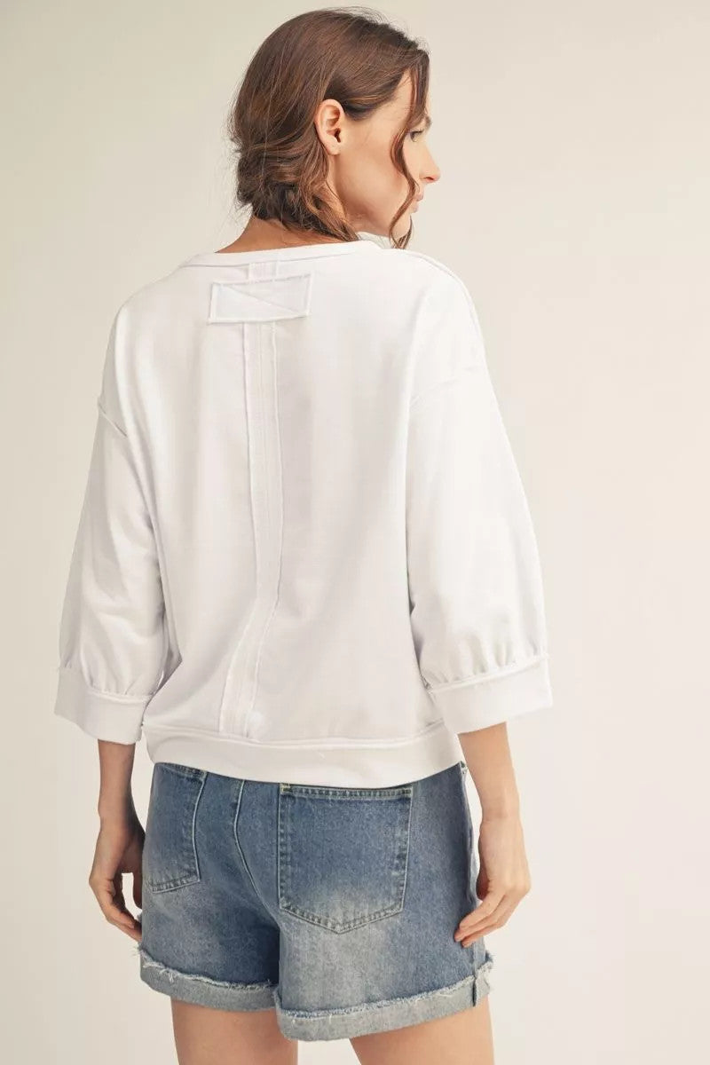 Millie casual top in washed fabric with drop shoulders and raw cut edges.