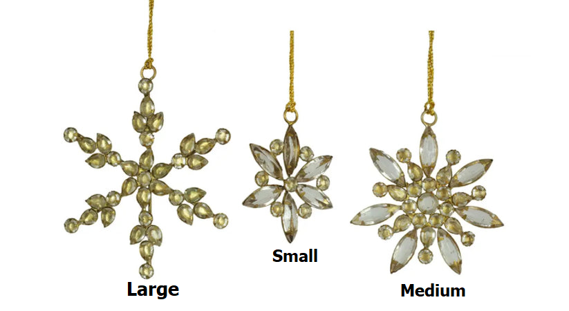 Metal snowflake ornament with glass jewels in gold color