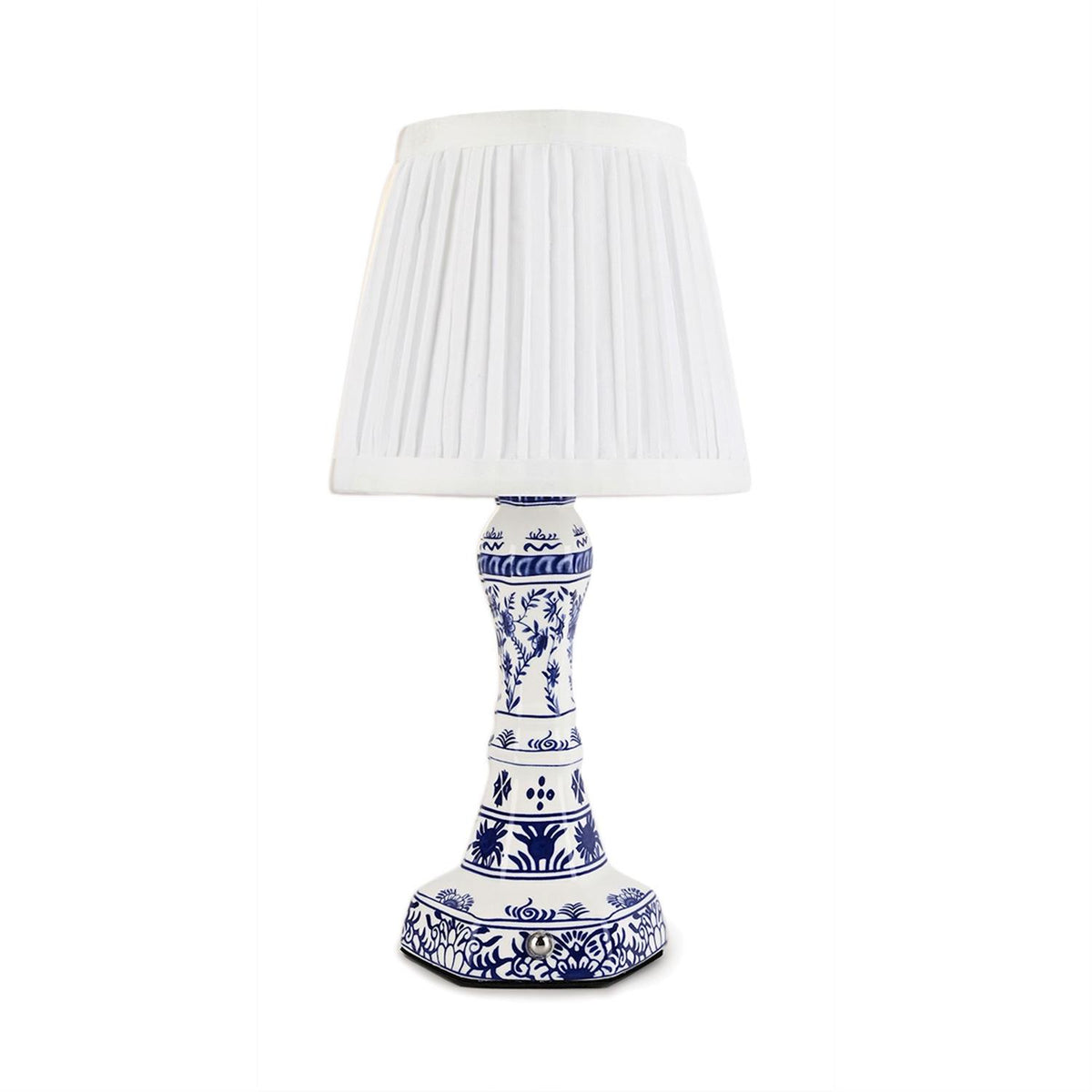 Cordless blue and white floral ceramic table lamp with a white pleated lampshade.