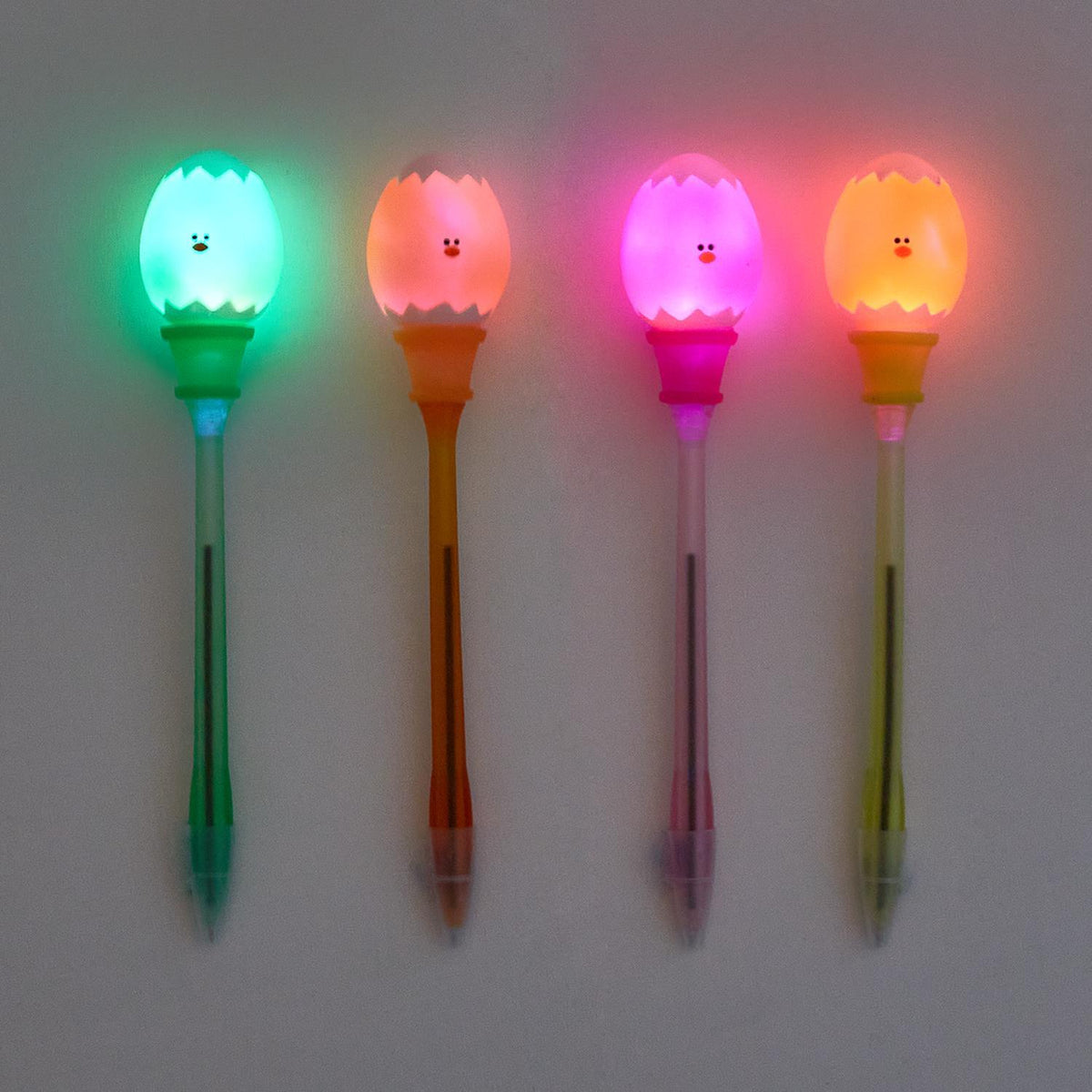 Neon yellow egg-shaped pen with a glowing light-up tip.