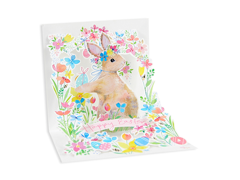 White envelope card with glitter finish featuring a garden rabbit illustration and ivory ribbon.