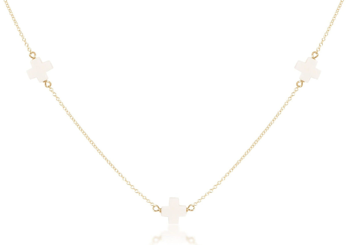 Gold-filled choker necklace featuring a signature cross pendant on an adjustable chain.