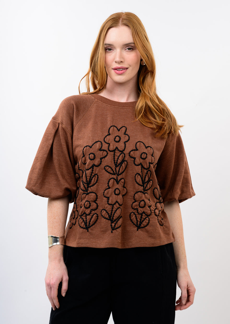 Brown French Terry crewneck with floral embroidery and pleated puffy elbow-length sleeves.