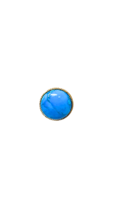 Oversized turquoise cabochon ring with a textured gold rope-style border.