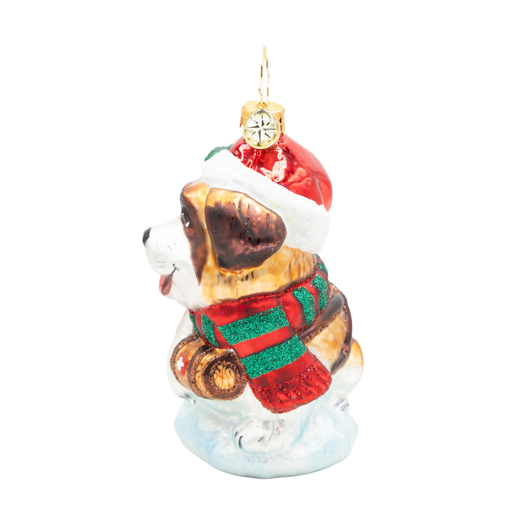 Glass Saint Bernard dog ornament wearing a red Santa hat and a red and green striped scarf.