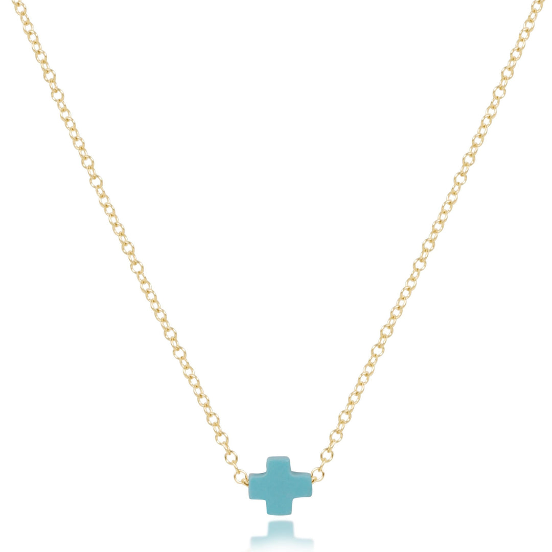 16-inch 14kt gold-filled chain necklace featuring a small turquoise-colored signature cross pendant.