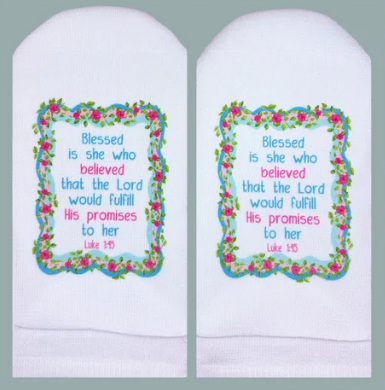White socks featuring the Bible verse Luke 1:45 inside a pink rose and blue vine border.