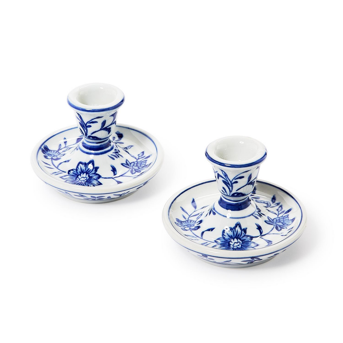 Set of two hand-painted blue and white ceramic taper candlestick holders with floral patterns.